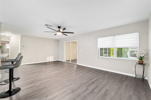 9729 SW 97th St, Ocala, FL 34481 - unfurnished living room with a ceiling fan, wood finished floors, and baseboards