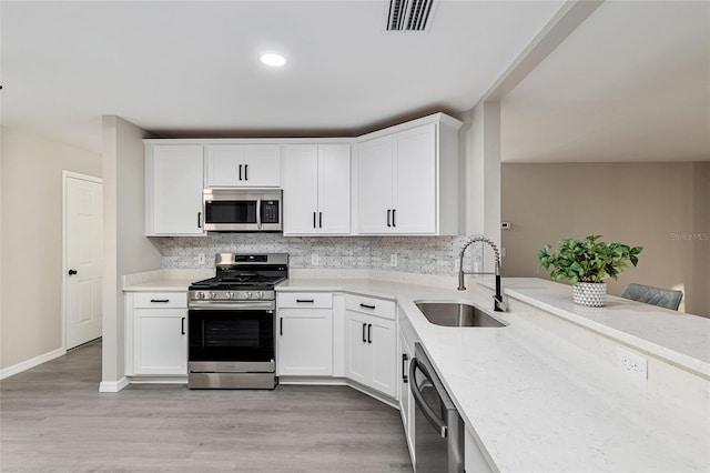 9729 SW 97th St, Ocala, FL 34481 - kitchen featuring stainless steel appliances, a sink, light countertops, and tasteful backsplash
