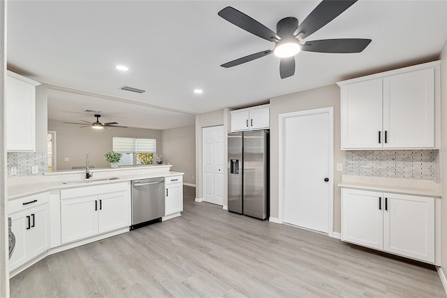 9729 SW 97th St, Ocala, FL 34481 - kitchen with appliances with stainless steel finishes, a sink, a ceiling fan, a peninsula, and tasteful backsplash