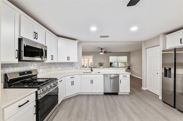 9729 SW 97th St, Ocala, FL 34481 - kitchen with stainless steel appliances, a ceiling fan, a sink, light wood-type flooring, and recessed lighting