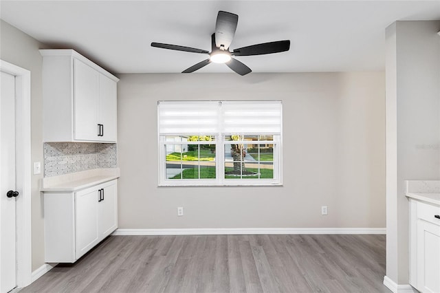 9729 SW 97th St, Ocala, FL 34481 - unfurnished dining area featuring light wood-style flooring, a ceiling fan, and baseboards