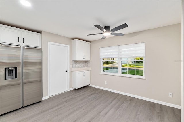 9729 SW 97th St, Ocala, FL 34481 - kitchen with stainless steel built in fridge, light wood finished floors, white cabinetry, ceiling fan, and baseboards
