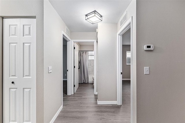 9729 SW 97th St, Ocala, FL 34481 - hallway featuring baseboards, wood finished floors, and a textured wall