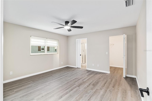 9729 SW 97th St, Ocala, FL 34481 - unfurnished bedroom featuring a spacious closet, wood finished floors, baseboards, a ceiling fan, and a closet