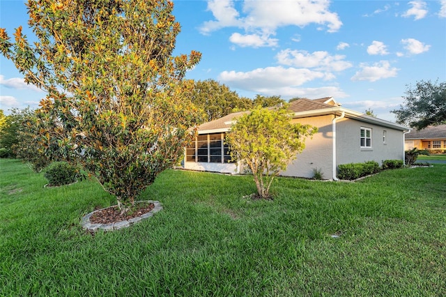 9729 SW 97th St, Ocala, FL 34481 - rear view of property with stucco siding, a lawn, and a sunroom
