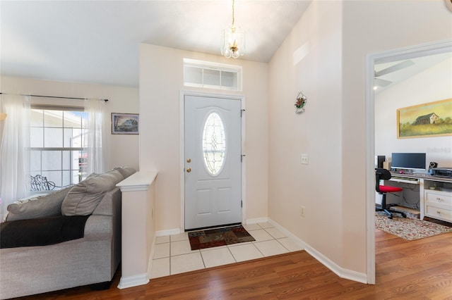 5920 SW 88th Pl, Ocala, FL 34476 - foyer entrance featuring wood finished floors, a chandelier, and baseboards