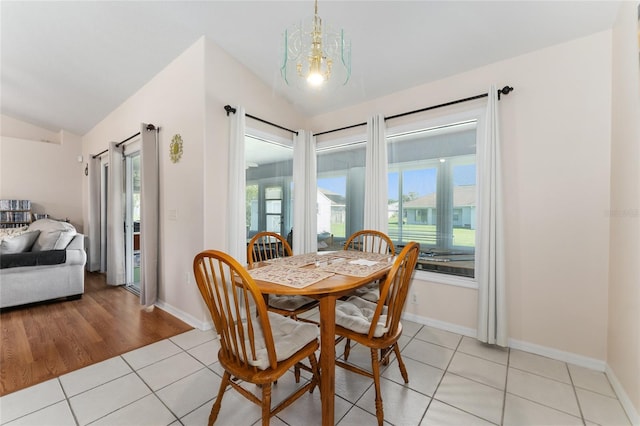 5920 SW 88th Pl, Ocala, FL 34476 - dining space featuring vaulted ceiling, light tile patterned floors, a chandelier, and baseboards