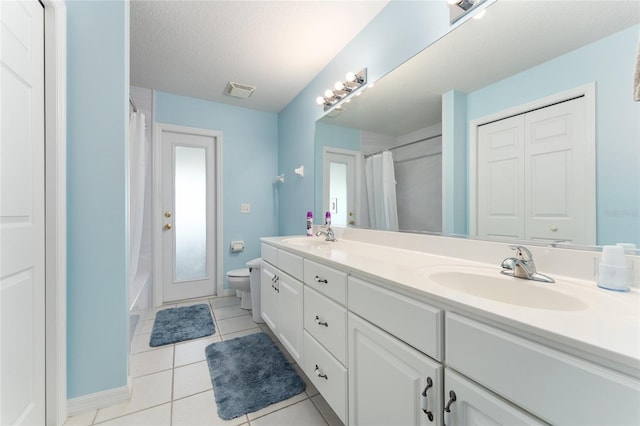 5920 SW 88th Pl, Ocala, FL 34476 - full bath featuring tile patterned flooring, toilet, double vanity, and a textured ceiling