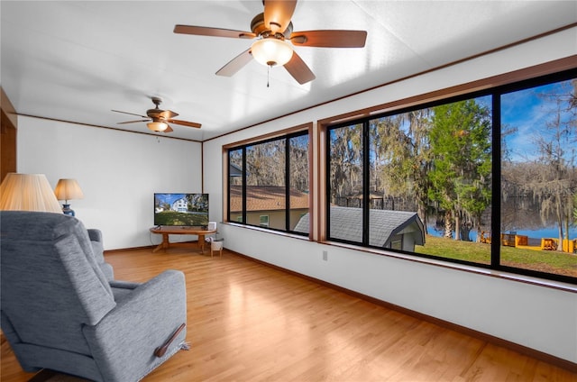 6620 S Merleing Loop, Floral City, FL 34436 - sitting room featuring wood finished floors, baseboards, and a ceiling fan