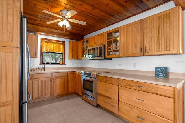6620 S Merleing Loop, Floral City, FL 34436 - kitchen with stainless steel appliances, wood ceiling, ceiling fan, light countertops, and glass insert cabinets