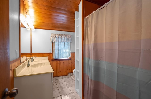 6620 S Merleing Loop, Floral City, FL 34436 - full bath with a wainscoted wall, toilet, vanity, tile patterned flooring, and wooden walls