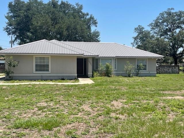 6051 NE 25th Ave, Ocala, FL 34479 - ranch-style home with metal roof and a front yard
