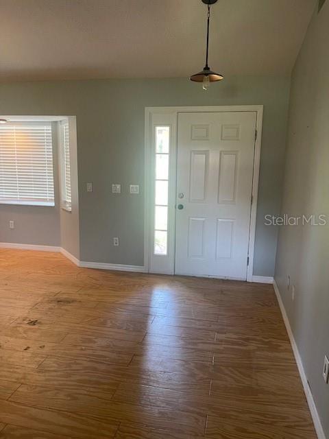 6051 NE 25th Ave, Ocala, FL 34479 - foyer entrance with baseboards and wood finished floors