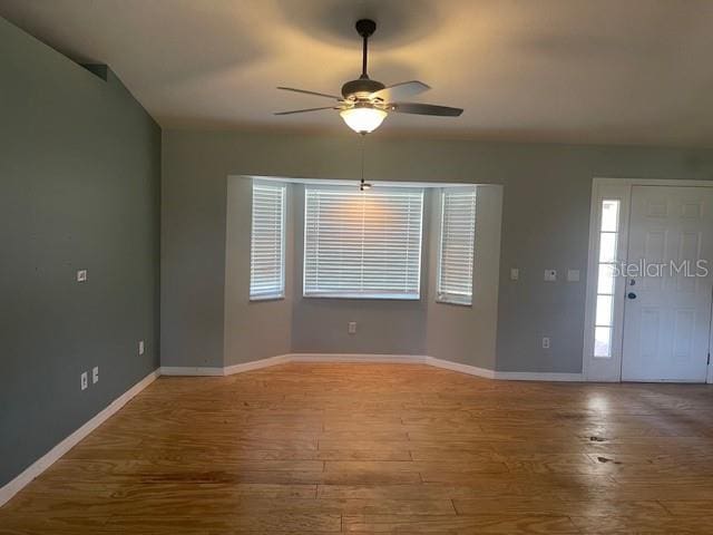 6051 NE 25th Ave, Ocala, FL 34479 - entrance foyer with a ceiling fan, wood finished floors, baseboards, and plenty of natural light