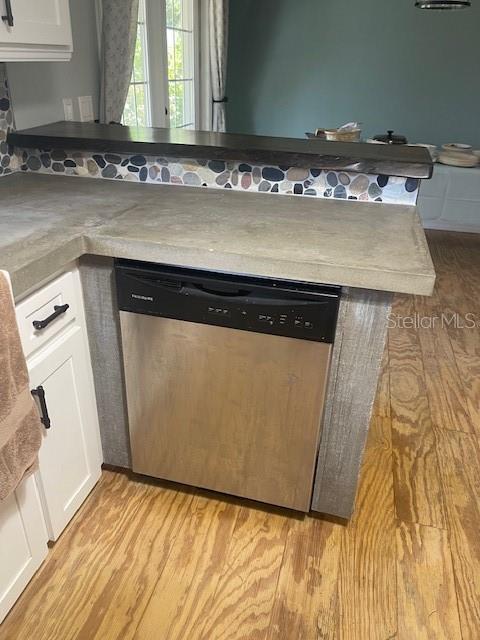 6051 NE 25th Ave, Ocala, FL 34479 - kitchen with dishwasher, light wood finished floors, and white cabinets