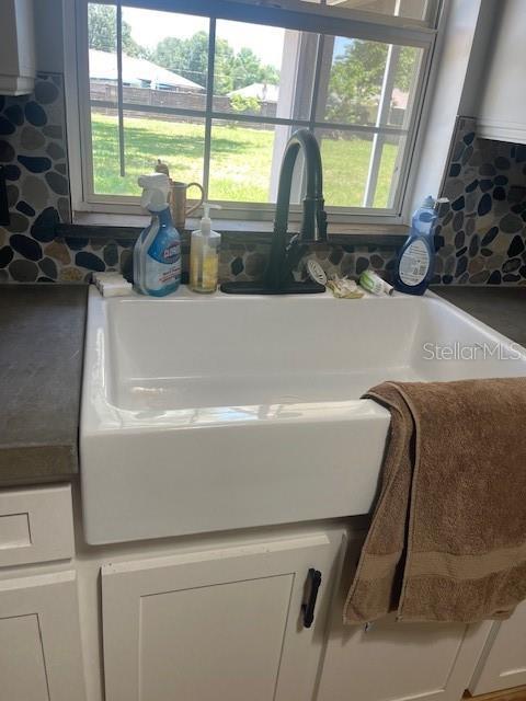6051 NE 25th Ave, Ocala, FL 34479 - kitchen view of white cabinets and a sink