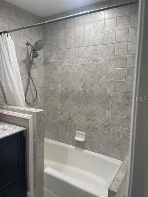 6051 NE 25th Ave, Ocala, FL 34479 - bathroom featuring shower / bath combo with shower curtain and vanity