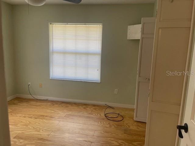 6051 NE 25th Ave, Ocala, FL 34479 - spare room featuring light wood-style flooring, a ceiling fan, and baseboards