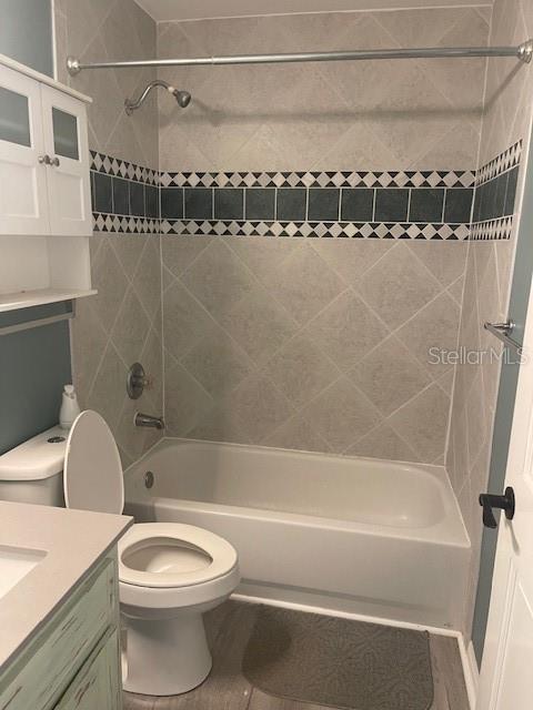 6051 NE 25th Ave, Ocala, FL 34479 - full bath featuring tub / shower combination, vanity, toilet, and tile patterned floors