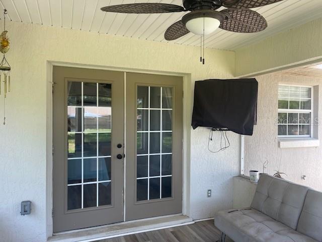 6051 NE 25th Ave, Ocala, FL 34479 - doorway to property featuring french doors, stucco siding, and ceiling fan