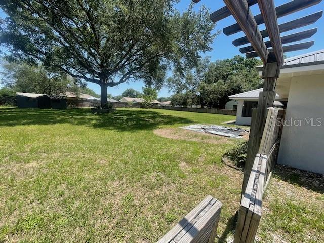6051 NE 25th Ave, Ocala, FL 34479 - view of green lawn with a pergola