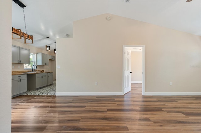 5193 NW 61st Ave, Ocala, FL 34482 - unfurnished living room featuring a sink, dark wood finished floors, baseboards, and high vaulted ceiling