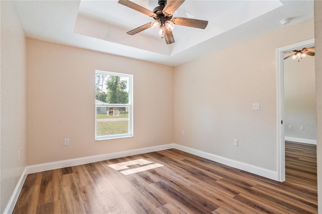 5193 NW 61st Ave, Ocala, FL 34482 - unfurnished room featuring wood finished floors, a tray ceiling, ceiling fan, and baseboards
