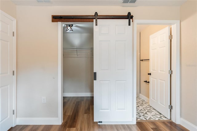 5193 NW 61st Ave, Ocala, FL 34482 - unfurnished bedroom with a closet, wood finished floors, baseboards, and a barn door