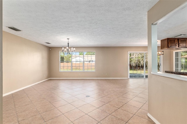 1404 SE 40th Ct, Ocala, FL 34471 - spare room featuring a chandelier, light tile patterned floors, a textured ceiling, and baseboards