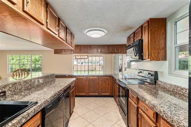 1404 SE 40th Ct, Ocala, FL 34471 - kitchen featuring black appliances, brown cabinetry, healthy amount of natural light, light tile patterned floors, and a textured ceiling