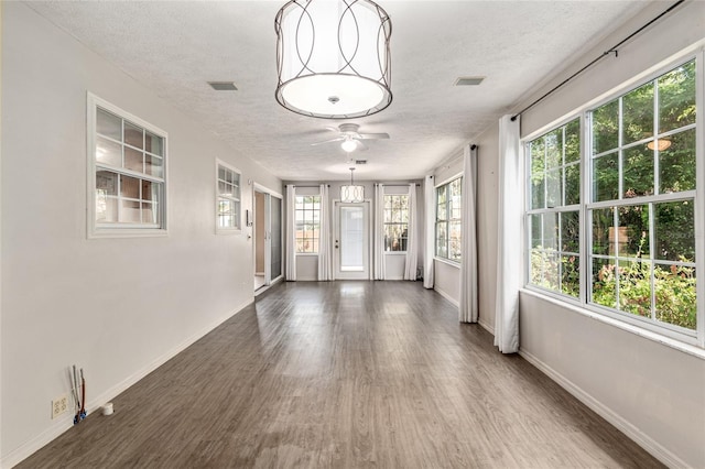 1404 SE 40th Ct, Ocala, FL 34471 - empty room featuring a textured ceiling, ceiling fan, wood finished floors, and baseboards