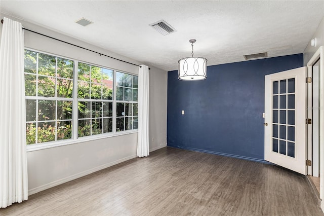 1404 SE 40th Ct, Ocala, FL 34471 - empty room with wood finished floors, baseboards, and a textured ceiling