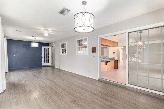 1404 SE 40th Ct, Ocala, FL 34471 - empty room featuring wood finished floors, a ceiling fan, and baseboards