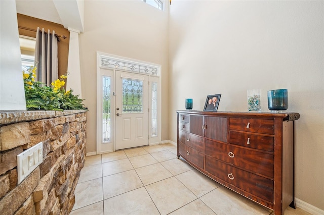 2948 W Henley Ln, Dunnellon, FL 34433 - entrance foyer featuring healthy amount of natural light, light tile patterned flooring, a high ceiling, and baseboards