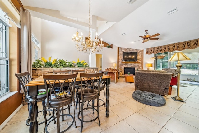 2948 W Henley Ln, Dunnellon, FL 34433 - dining room with a fireplace, vaulted ceiling, ceiling fan, a chandelier, and light tile patterned floors