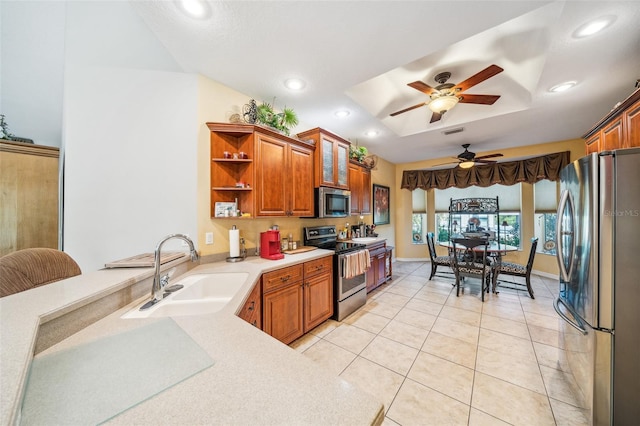 2948 W Henley Ln, Dunnellon, FL 34433 - kitchen with stainless steel appliances, a sink, light countertops, a ceiling fan, and brown cabinets
