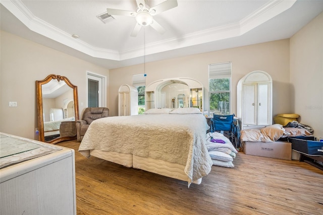 2948 W Henley Ln, Dunnellon, FL 34433 - bedroom with a tray ceiling, wood finished floors, crown molding, and ceiling fan