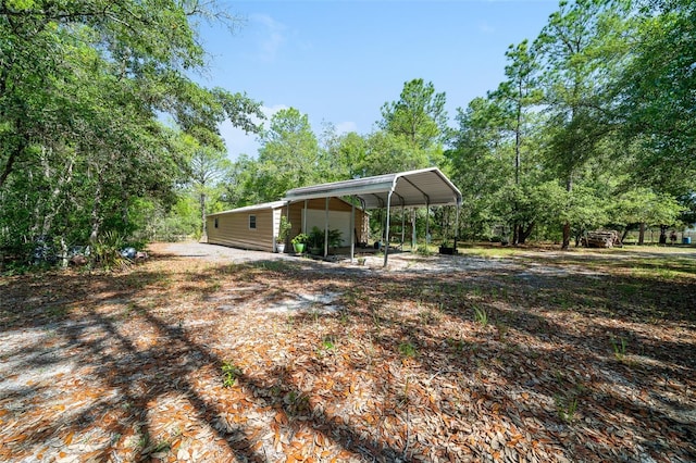 2948 W Henley Ln, Dunnellon, FL 34433 - view of yard featuring a detached carport and driveway