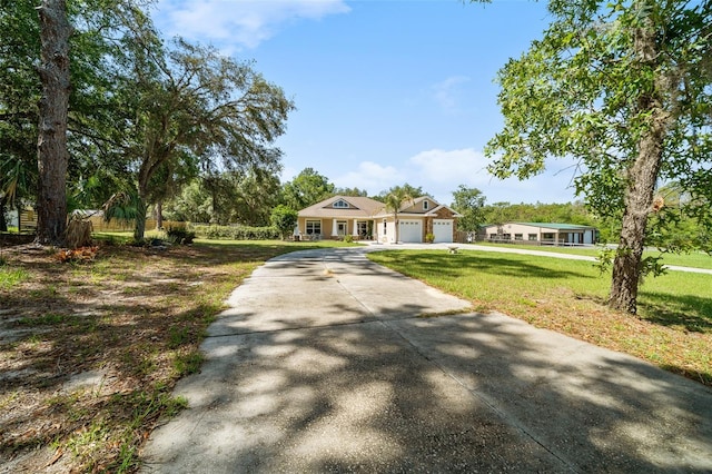 2948 W Henley Ln, Dunnellon, FL 34433 - view of front of home featuring a garage, a front yard, and concrete driveway