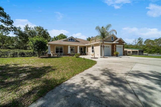 2948 W Henley Ln, Dunnellon, FL 34433 - view of front facade featuring an attached garage, a porch, a front lawn, and driveway