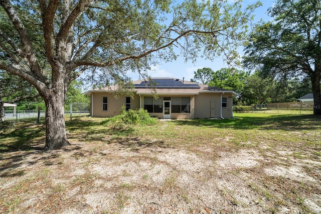 2948 W Henley Ln, Dunnellon, FL 34433 - back of property with roof mounted solar panels and stucco siding