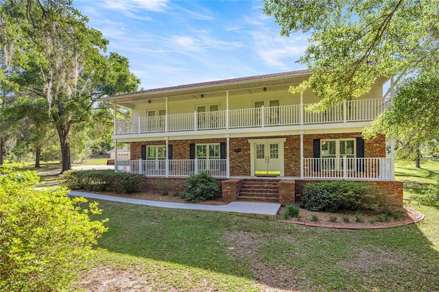 20861 SW 81st Loop, Dunnellon, FL 34431 - view of front property with covered porch, french doors, a front yard, and brick siding