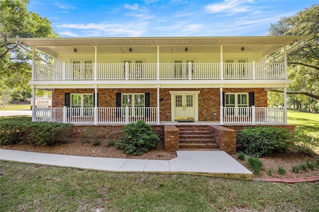 20861 SW 81st Loop, Dunnellon, FL 34431 - front of property with a porch, french doors, a balcony, and a front lawn