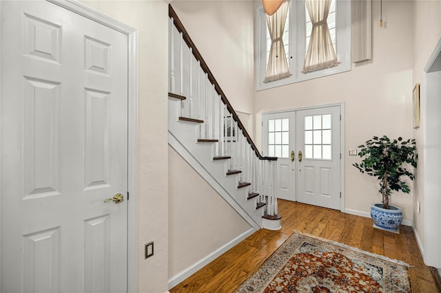 20861 SW 81st Loop, Dunnellon, FL 34431 - entryway featuring stairs, baseboards, wood finished floors, and a high ceiling