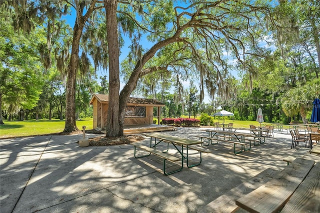 20861 SW 81st Loop, Dunnellon, FL 34431 - view of patio / terrace with an outdoor structure and view of scattered trees