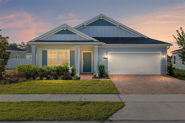 1875 NW 44 Court Rd, Ocala, FL 34482 - view of front of home featuring board and batten siding, decorative driveway, and an attached garage