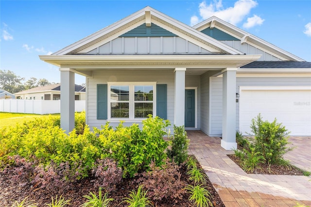 1875 NW 44 Court Rd, Ocala, FL 34482 - view of front of property featuring board and batten siding, covered porch, and an attached garage