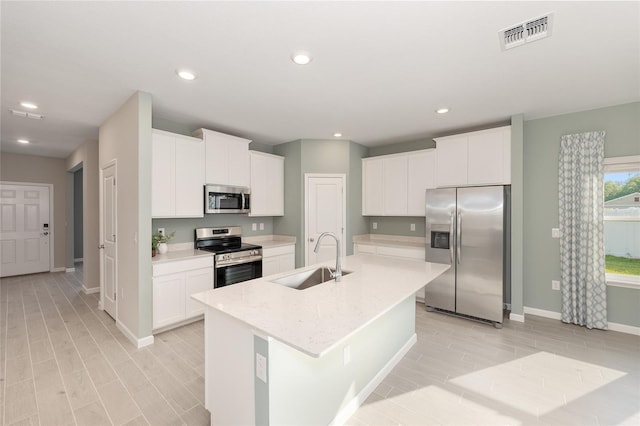 1875 NW 44 Court Rd, Ocala, FL 34482 - kitchen featuring appliances with stainless steel finishes, a sink, baseboards, white cabinets, and recessed lighting