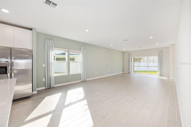 1875 NW 44 Court Rd, Ocala, FL 34482 - unfurnished living room featuring baseboards, light wood-style floors, and recessed lighting