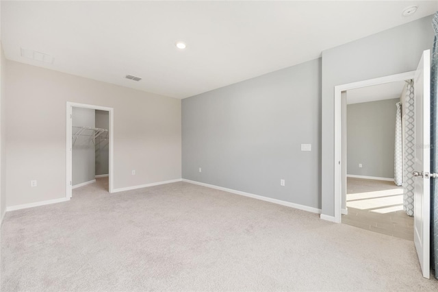 1875 NW 44 Court Rd, Ocala, FL 34482 - unfurnished bedroom with light colored carpet, a spacious closet, baseboards, a closet, and recessed lighting